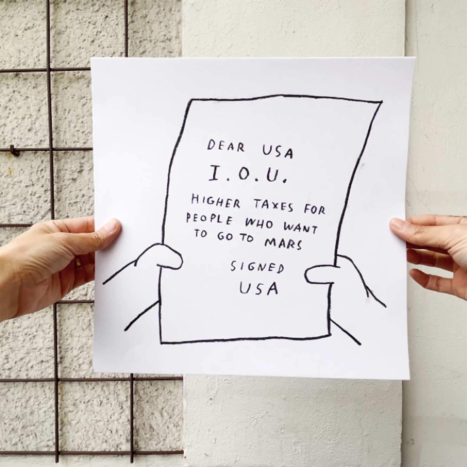 This still from IOU 4 USA depicts a square charcoal drawing held up by two hands. The drawing is of a frame from The Simpsons and shows an IOU note in Homer’s hands. The note reads: “DEAR USA I.O.U. HIGHER TAXES FOR PEOPLE WHO WANT TO GO TO MARS SIGNED USA”.