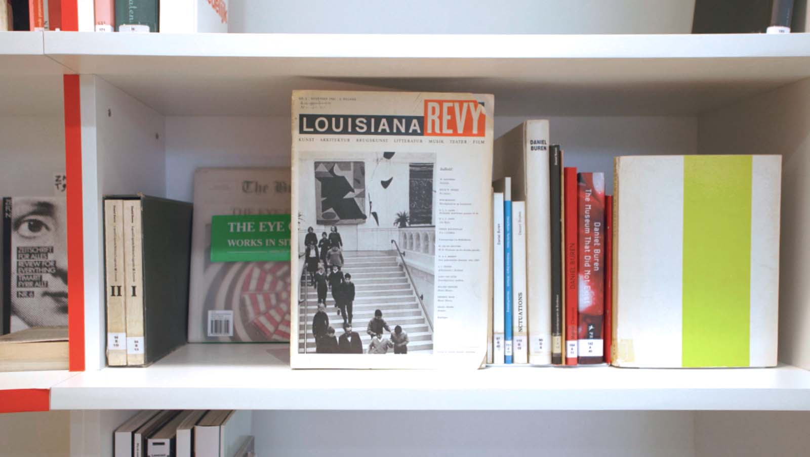 Fig. 9: Shelf dedicated to the monumental staircase of the museum, showing the cover of Museums by Artists, depicting Daniel Buren’s iconic vertical stripes. Moving Thinking, 2015. Photo: Fabian Landewee