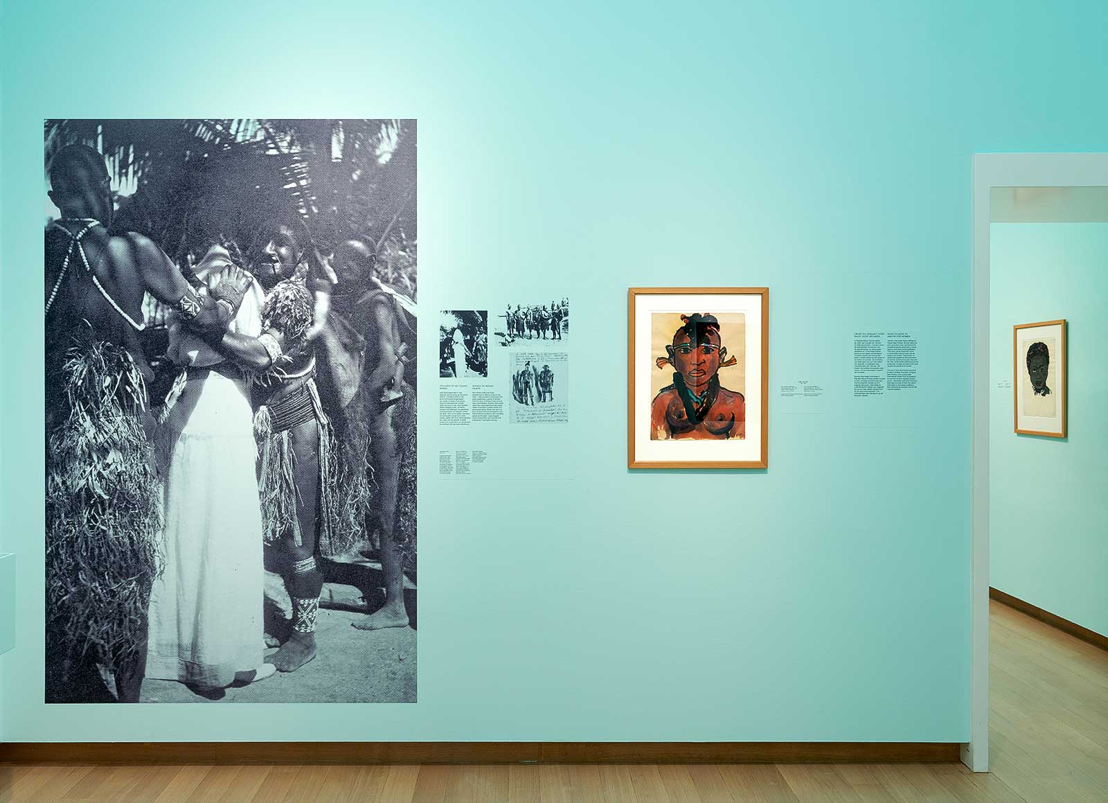 Fig. 4 Exhibition view of Kirchner and Nolde: Expressionism. Colonialism. at Stedelijk Museum Amsterdam, 2021. Photo: Gert-Jan van Rooij. Left: Ada Nolde with indigenous women on the island of Pak or Manus, Papua New Guinea, 1914. Photographer unknown, Archive of the Nolde Foundation Seebüll.