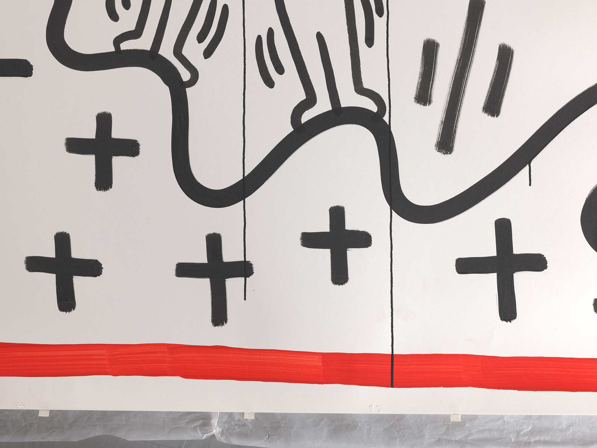Close-up photograph of the second section of Amsterdam Notes. The texture of the lines, the paint drips, staple holes, and cloth hinges (added retrospectively for the 1992 installation) are clearly visible. Photo: Rik Klein Gotink. Archive Stedelijk Museum Amsterdam. Amsterdam Notes © Keith Haring Foundation.