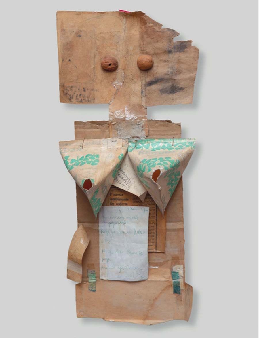 A Milk Carton Woman. 1980s. Cardboard, paper, newspaper cutout, milk carton, walnut shell.