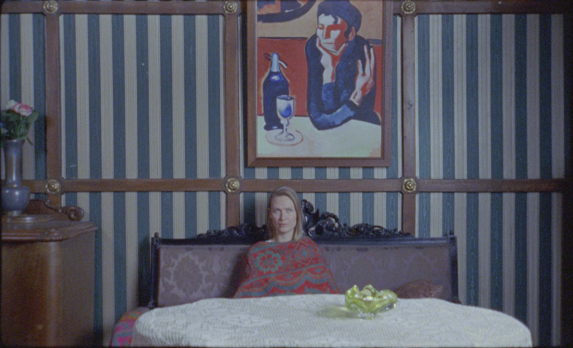 Wilhelm Sasnal, The Assistant, 2024, film still. Seen in the film still is Wilhelm Sasnal’s Untitled (after “The Absinthe Drinker” by Pablo Picasso), 2023, oil on canvas, incl. frame: 110 × 80 cm. Courtesy the artist and Foksal Gallery Foundation.